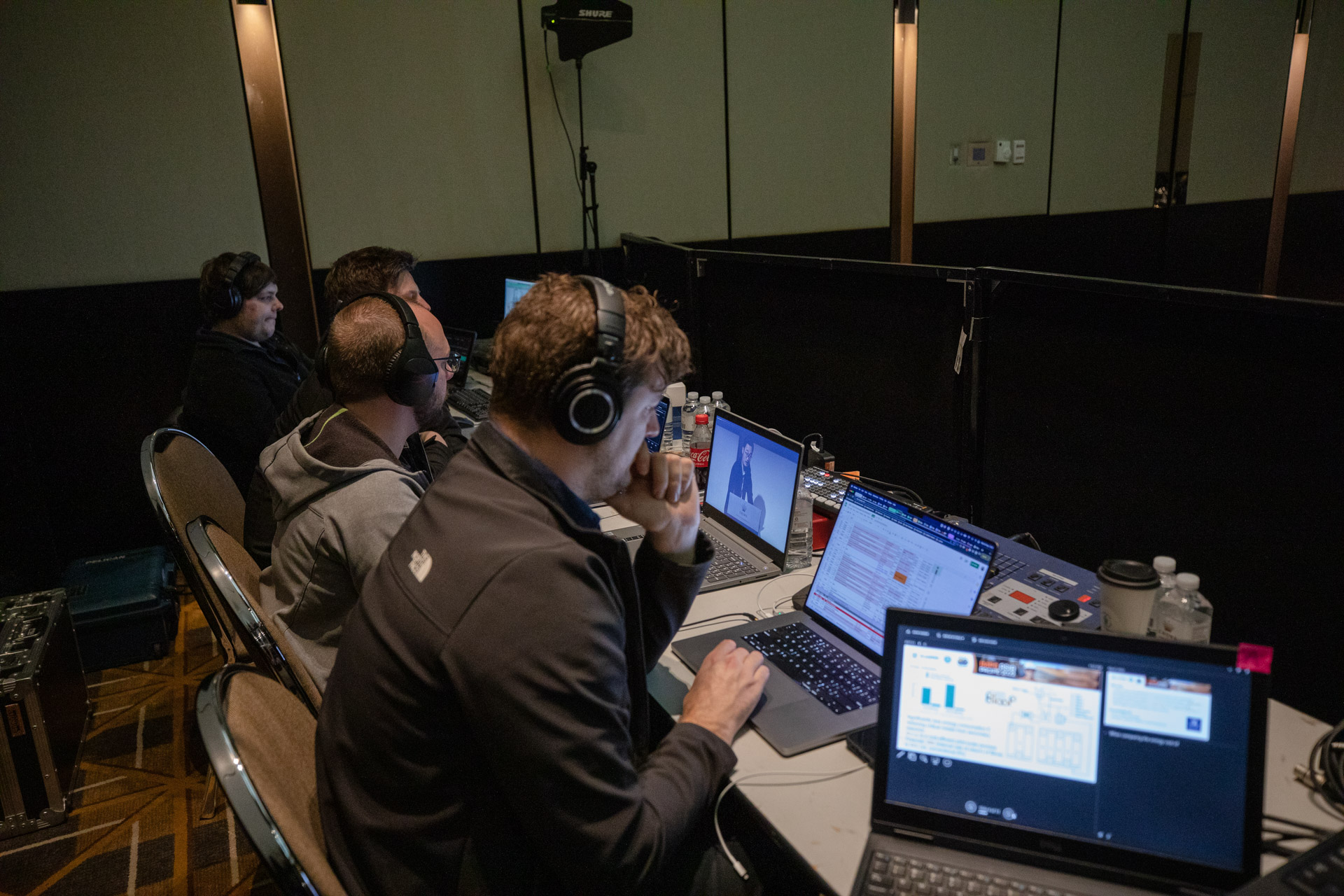 livestream technicians sitting behind their laptops