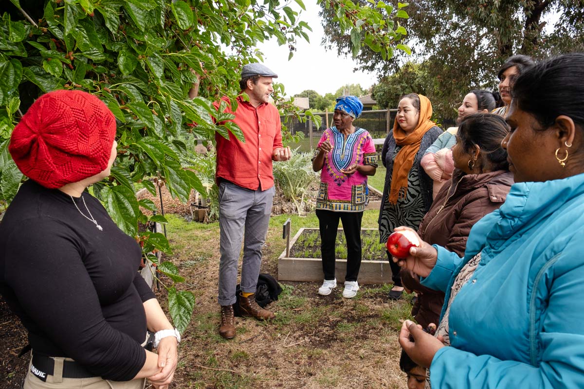 Cooking Without Borders - group of people standing outside in a vegetable garden