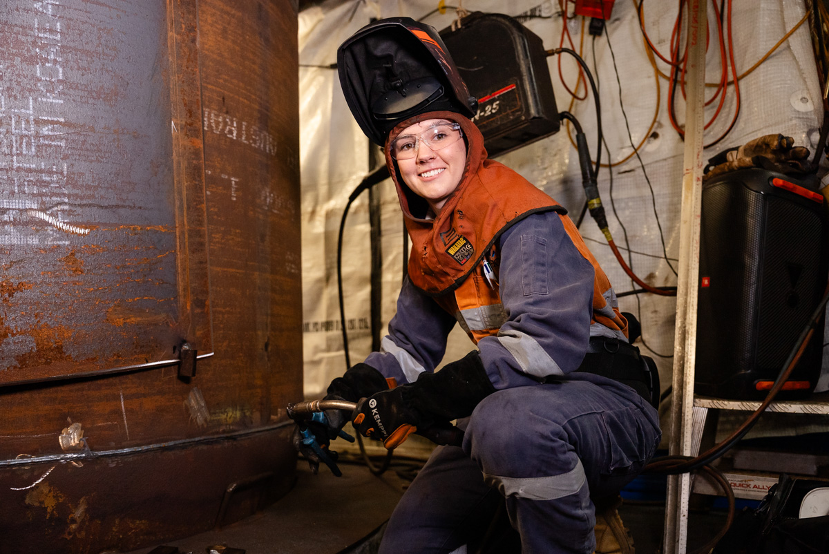 Young woman welding
