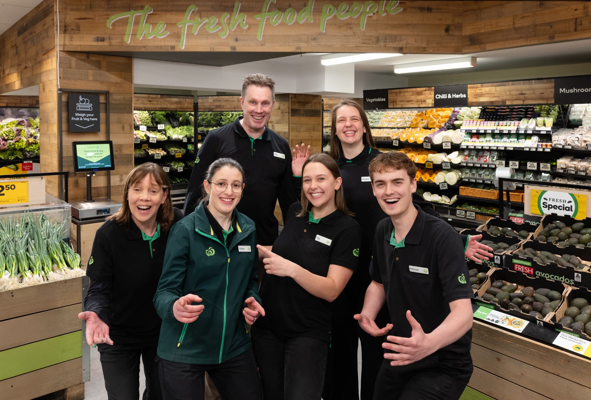 010-WoolworthsMitchamTeam-28Oct25 (1) Woolies team in front of fresh produce section, smiling
